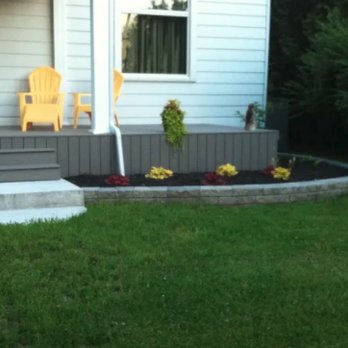 Harris Gardens - the front of a house with a lawn and yellow chairs - Lawn Services Near Me - Teeswater, Ontario Harris Gardens - the front of a house with a lawn and yellow chairs - Lawn Services Near Me - Teeswater, Ontario
