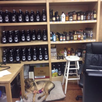 17th Ave Liquor Boutique - a dog laying on the floor - Beer, Wine & Spirits Near Me - Calgary, Alberta