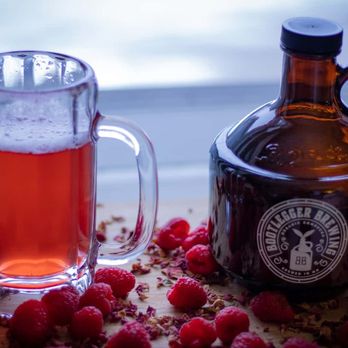 Bootlegger Brewing - a glass of raspberry syrup and a jug of raspberry syrup - Specialty Food Near Me - Apple Valley, Minnesota