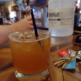 Broadslab Distillery - a glass of orange juice with a straw - Tours Near Me - Benson, North Carolina Broadslab Distillery - a glass of orange juice with a straw - Tours Near Me - Benson, North Carolina