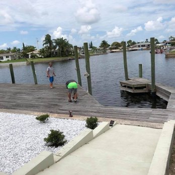 Coastline Const Services - a man and a boy on a dock - Masonry/Concrete Near Me