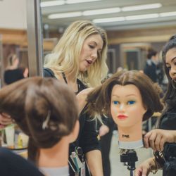 Cinta Aveda Institute - Student working on mannequin head