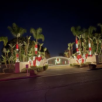 Hanson Holiday Lighting - Red and warm white palms, warm white on the gate/fence line, and a stunning 48" Lit wreath on the gate to complete this look! - Holiday Decorating Services Near Me Hanson Holiday Lighting - Red and warm white palms, warm white on the gate/fence line, and a stunning 48" Lit wreath on the gate to complete this look! - Holiday Decorating Services Near Me