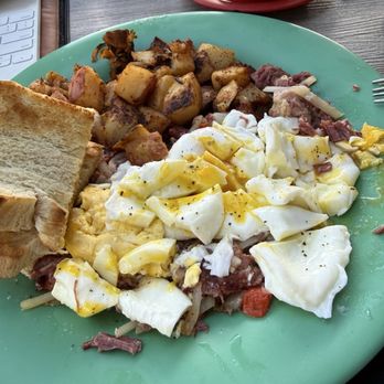 Jan's Place - Great corned beef hash topped by overcooked eggs with a side of mushy home fries - Breakfast & Brunch Near Me - Jensen Beach, Florida