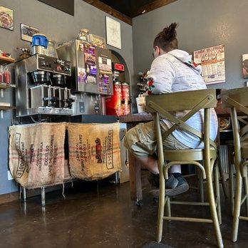 Black Dog - a man sitting at a table in a restaurant - Sandwiches Near Me - Booneville, Arkansas