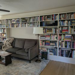 Mt. Tabor Construction - Bookcase built by Rob. It was difficult because the floor isn't level, and we wanted it to surround the sofa. We are SO happy with it.