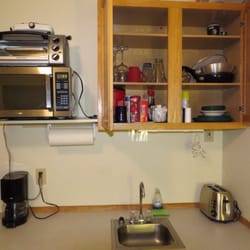 The Sea Lion Cove - Homer, Alaska - Kitchenette is adequate with a toaster oven, toaster, microwave, coffee maker, mini fridge, plates, and cups.