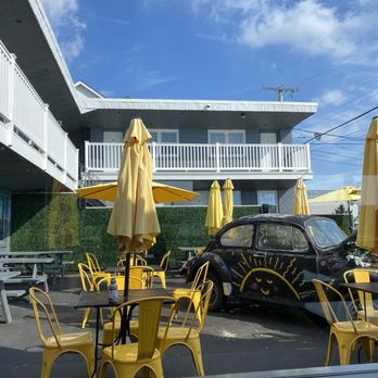 Bagel Time Cafe - View of outdoor seating from inside. Very cute out there. Kids were running around and checking out the old beetle car. - Cafes Near Me - Wildwood Crest, New Jersey