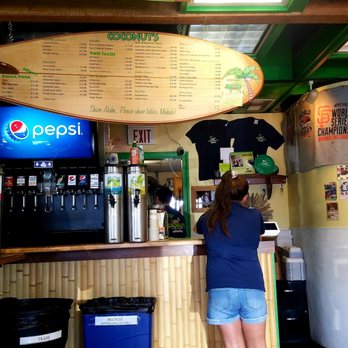 Coconuts Fish Cafe - Wall menu on a surfboard, and the ordering counter area. - Seafood Near Me - Kihei, Hawaii Coconuts Fish Cafe - Wall menu on a surfboard, and the ordering counter area. - Seafood Near Me - Kihei, Hawaii