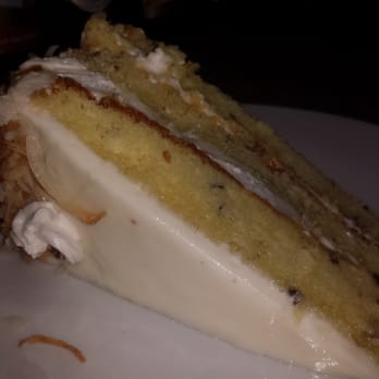 Candlelight - Italian creme slice: $4.60..... Italian creme cake with nuts& coconut, cream cheese filling& icing w/ toasted coconut on top - Coffee & Tea Near Me - San Antonio, Texas