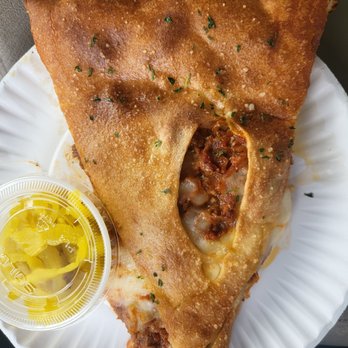 Mama Russo's Pizzeria - Slice of stuffed cheesesteak with a side of banana peppers - Italian Near Me - Trevose, Pennsylvania Mama Russo's Pizzeria - Slice of stuffed cheesesteak with a side of banana peppers - Italian Near Me - Trevose, Pennsylvania
