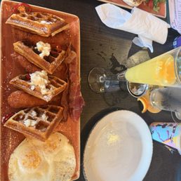 Chicken, waffles, bacon and eggs with hot honey and syrup. Chicken, waffles, bacon and eggs with hot honey and syrup.