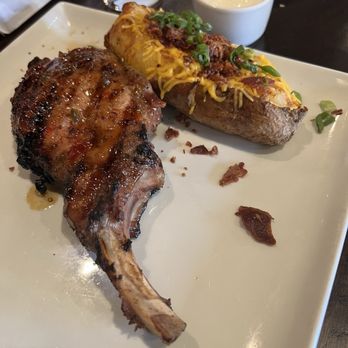 Kingfish Kitchen & Cocktails - Pork chop and baked potato - Cajun/Creole Near Me - New Orleans, Louisiana Kingfish Kitchen & Cocktails - Pork chop and baked potato - Cajun/Creole Near Me - New Orleans, Louisiana