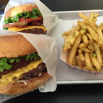 TrueBurger - True Deluxe Burger (front), Bacon Cheesy Trueburger (back), garlic fries (right) - Burgers Near Me - Oakland, California TrueBurger - True Deluxe Burger (front), Bacon Cheesy Trueburger (back), garlic fries (right) - Burgers Near Me - Oakland, California
