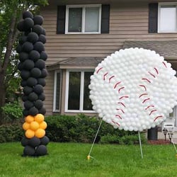 Andon Balloons & Signs - Ball and bat at a graduation party.  Withstood the rain