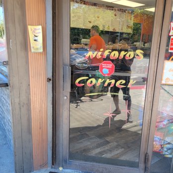 Niforos Corner - the reflection of a man in the window - Coffee & Tea Near Me - Long Island City, New York