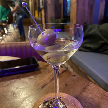 Dram & Draught - a martini with olives in it - Cocktail Bars Near Me - Wilmington, North Carolina