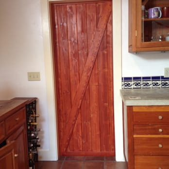 Acha Construction - Interior view of Barn door (barn style kitchen doors in lieu of pocket doors) by Acha Construction - General Contractors Near Me