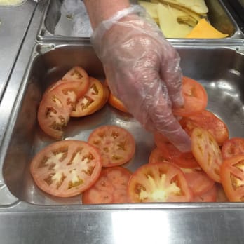 Publix - a person putting tomatoes in a sink - Grocery Near Me - Largo, Florida