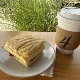 Bacon, egg, and cheese biscuit and drip coffee.