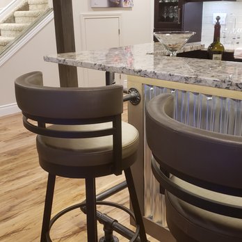 Homestyle Renovations - a kitchen with a bar and stools - General Contractors Near Me - Belle River, Ontario