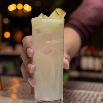 Rebellion Kitchen + Bar - a person holding a drink - Italian Near Me - Danbury, Connecticut Rebellion Kitchen + Bar - a person holding a drink - Italian Near Me - Danbury, Connecticut