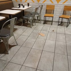 McDonald's - The floor has soda on it and food was left in the floor