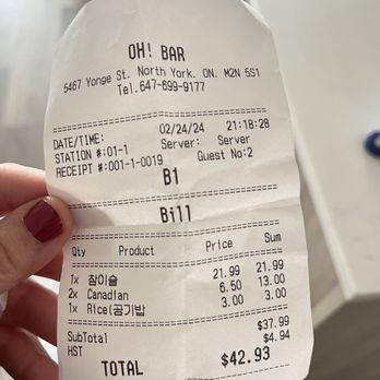 Oh Bar - a person holding a receipt in their hand - Bars Near Me - Toronto, Ontario Oh Bar - a person holding a receipt in their hand - Bars Near Me - Toronto, Ontario