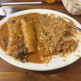 Enchilada dinner- asada with red sauce . Meat flavorful . Rice and beans tasty as well . Perfect Enchilada dinner- asada with red sauce . Meat flavorful . Rice and beans tasty as well . Perfect