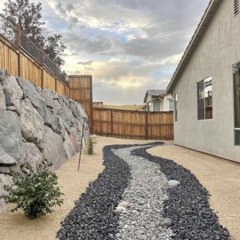 The Yard Guys - a gravel path in between two houses - Irrigation Near Me The Yard Guys - a gravel path in between two houses - Irrigation Near Me