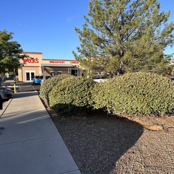 Weck's - a parking lot with a tree in the foreground - Breakfast & Brunch Near Me - Albuquerque, New Mexico