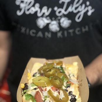 Flora & Lily's Mexican Kitchen - a person holding a box of nachos - Food Trucks Near Me Flora & Lily's Mexican Kitchen - a person holding a box of nachos - Food Trucks Near Me