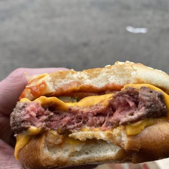 McDonald's - a hand holding a sandwich with meat and cheese - Fast Food Near Me - Ann Arbor, Michigan McDonald's - a hand holding a sandwich with meat and cheese - Fast Food Near Me - Ann Arbor, Michigan