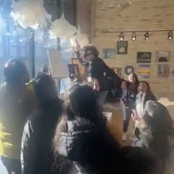 Michigan [AR] Scavenger Hunt - a group of people dancing in a cafe - Scavenger Hunts Near Me - Grand Rapids, Michigan