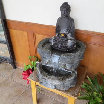 Yang's Kitchen Chinese Restaurant - a buddha statue and a water fountain - Chinese Near Me - Waller, Texas