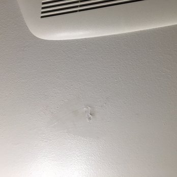 California Showcase Construction - Hole in the ceiling when they were trying to install vent fan. They decided to fix it with silicone. They did not fix this. - Windows Installation Near Me - Riverside, California