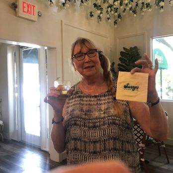 Sunny's - Rose Ryan in the dining room of Sunny's holding a Sunny's cocktail napkin & enjoying a bourbon old fashioned! Yummy!!! - Breakfast & Brunch Near Me - Boerne, Texas