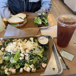 Kale Caesar and tea and chicken salad sandwich with lemonade