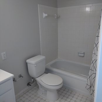 AKM Construction - a bathroom with a toilet and bathtub - Landscaping Near Me AKM Construction - a bathroom with a toilet and bathtub - Landscaping Near Me