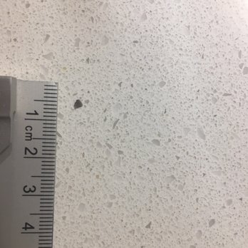 US Granite - The black rock that was no where else on the entire slab. Inconveniently located right in the middle of the kitchen island. - Kitchen & Bath Near Me - Auburn, Washington