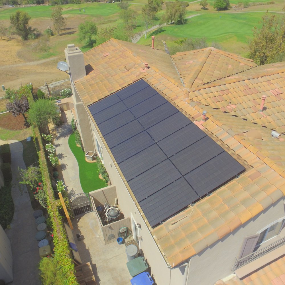 Solar panel installation with Spanish tile replaced by composite shingles under panels. Solar panel installation with Spanish tile replaced by composite shingles under panels.