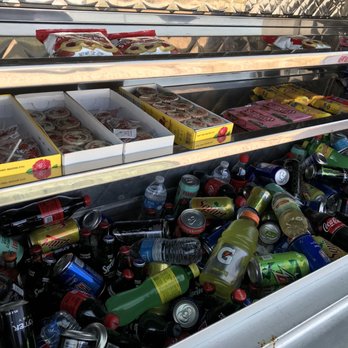 Cukis - a display case filled with cans of soda - Food Trucks Near Me