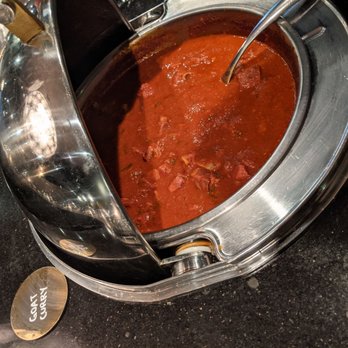 Zaika Bistro & Bar - a pot of stew with a spoon in it - Indian Near Me - Edmonton, Alberta Zaika Bistro & Bar - a pot of stew with a spoon in it - Indian Near Me - Edmonton, Alberta