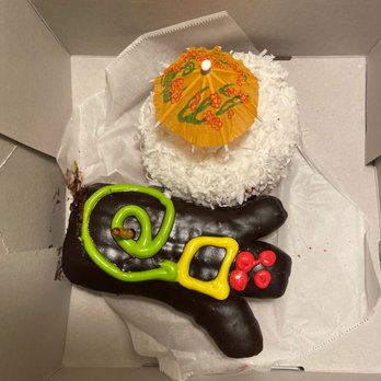 Voodoo Doughnut - Voodoo Doll and Guava Pina Colada donuts. - Bakeries Near Me - Orlando, Florida Voodoo Doughnut - Voodoo Doll and Guava Pina Colada donuts. - Bakeries Near Me - Orlando, Florida