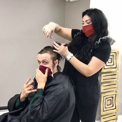 Zena Salon - Duja using safe practice for cutting hair.