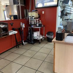 Fazoli's - Cleaning supplies behind the counter exposed to customers.