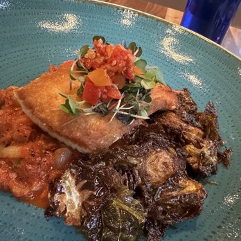 Andare Kitchen & Bar - Grilled Halibut with stewed tomatoes and grilled Brussels sprouts. - Pizza Near Me - Seattle, Washington