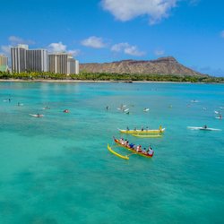 Outrigger canoe rides, a must do in hawaii, we surf the canoe on the waves along the surfers