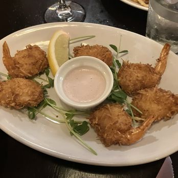 Kurt's Steakhouse - Coconut Shrimp garnished with locally sourced pea shoots - Steakhouses Near Me - Delafield, Wisconsin Kurt's Steakhouse - Coconut Shrimp garnished with locally sourced pea shoots - Steakhouses Near Me - Delafield, Wisconsin