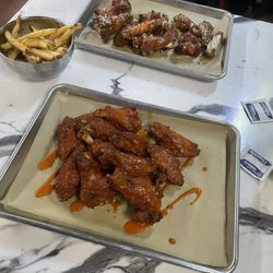 CJ's Sports Bar And Grill - Buffalo sauce and garlic parm! Monday night was $1 wing night